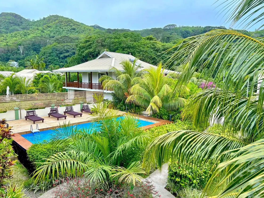 Escape to The Seaboards Apartments, nestled within a vibrant garden adorned with lush flowers and trees, on the breathtaking southwest of Mahe Island.