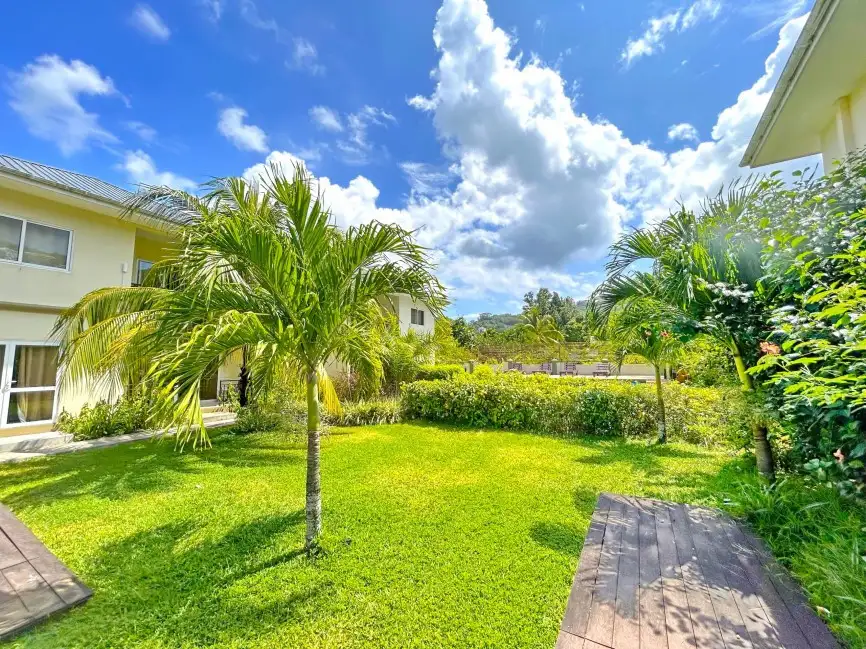 Escape to The Seaboards Apartments, nestled within a vibrant garden adorned with lush flowers and trees, on the breathtaking southwest of Mahe Island.