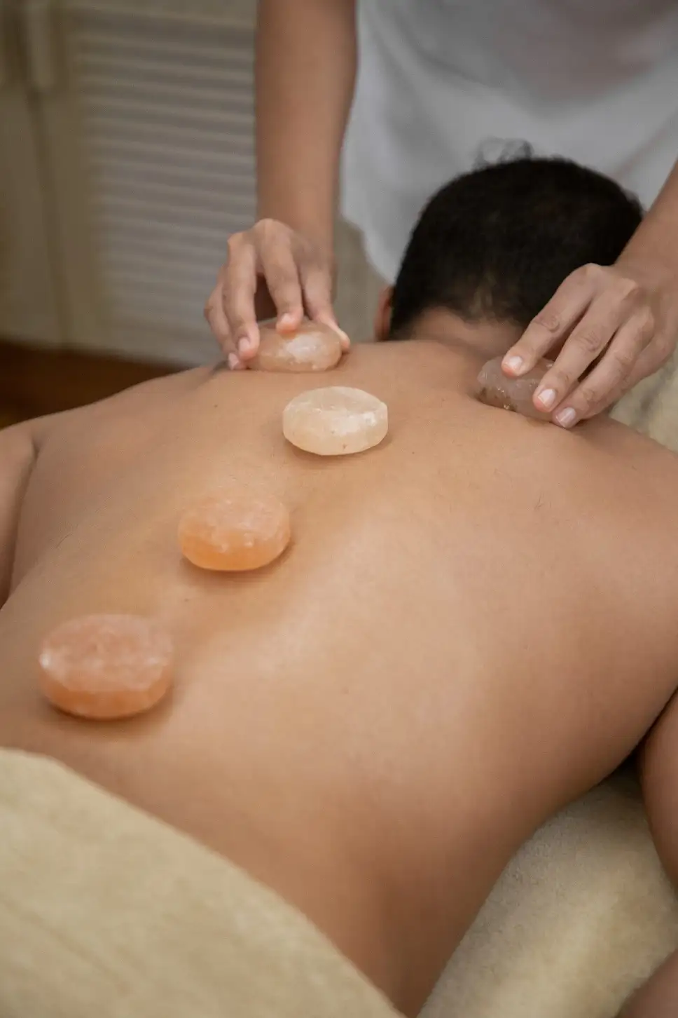 A hot stone massage is a type of massage therapy. It's used to help you relax and ease tense muscles and damaged soft tissues throughout your body.