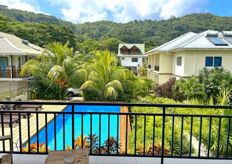 Escape to The Seaboards Apartments, nestled within a vibrant garden adorned with lush flowers and trees, on the breathtaking southwest of Mahe Island.